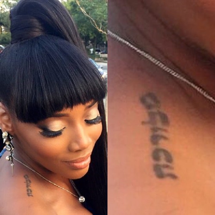 Yandy Smith showing her upper shoulder tattoo to public